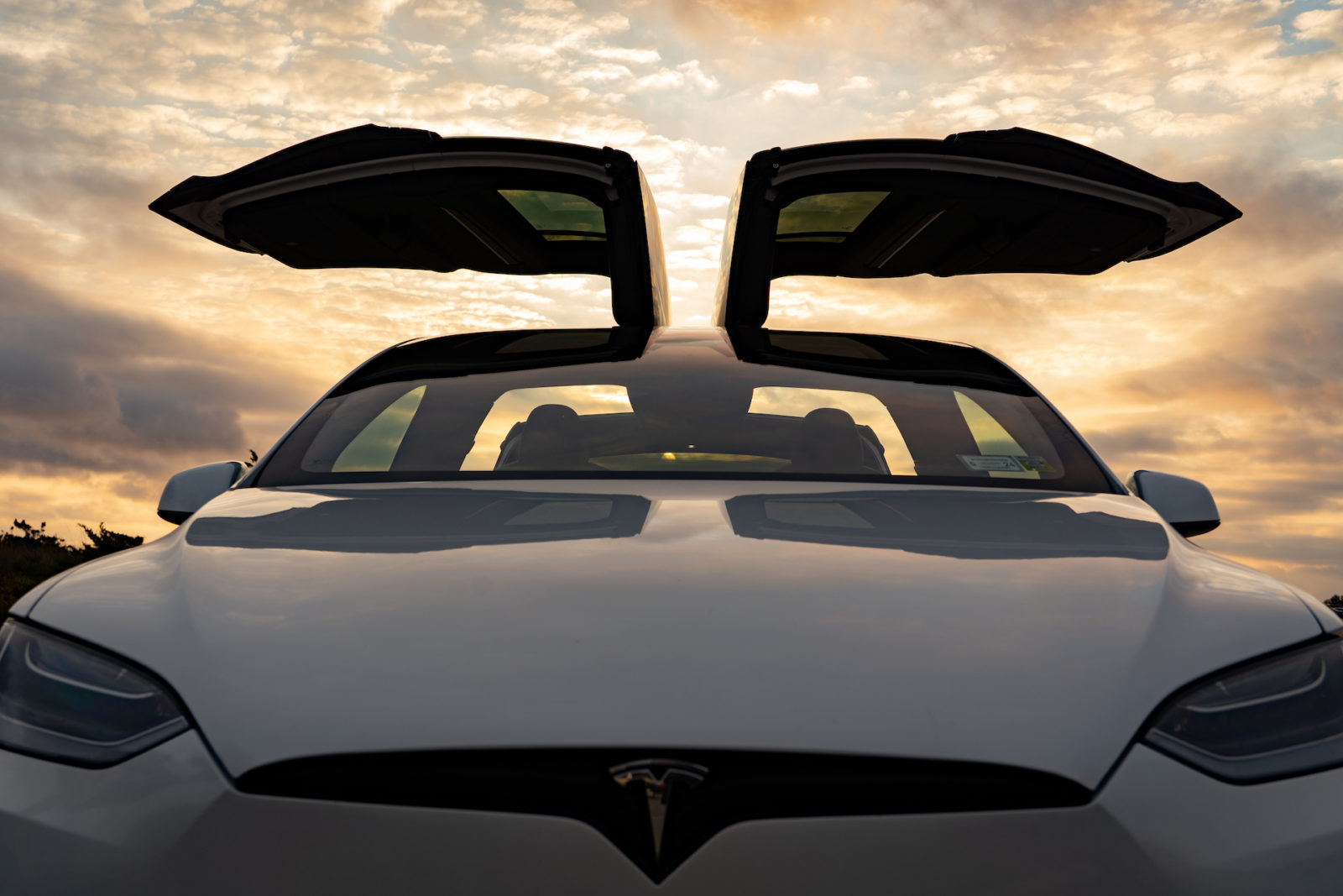 Front view of a 2022 Tesla Model X Plaid at sunset